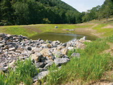 An erosion control pond is one of many environmental protocols on the job. (Photo by Carl Thiemann)
