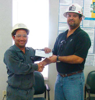 Rolayme Fabelo, left, is White Rock Quarries 2012 Safety Phrase contest winner with Chance Takers Are Accident Makers. At right is WRQ Safety Director Tony Diaz. (Photo by JR Payne)